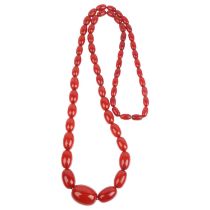 A long single-strand graduated cherry amber bead necklace, beads measure: 28.3-12.9mm, 46cm, 69.9g