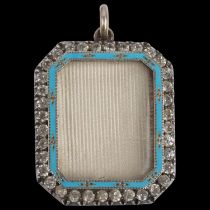 An early 20th century silver-gilt blue enamel and paste photo locket pendant, indistinct maker,