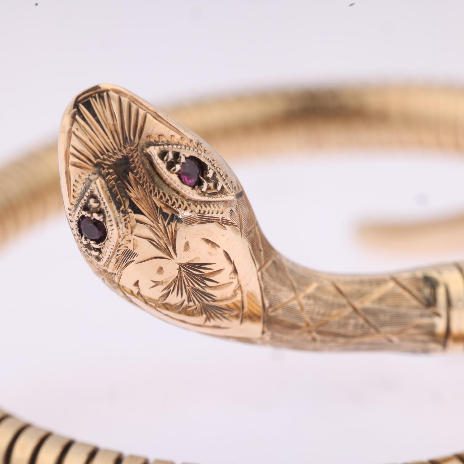 A late 20th century 9ct gold ruby figural coiled snake bangle, maker C&F, Birmingham 1971, - Image 2 of 4