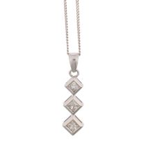 An 18ct white gold three stone diamond drop pendant, set with Princess-cut diamonds, total diamond