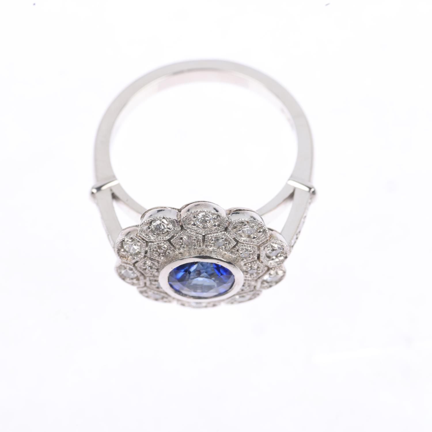 A platinum sapphire and diamond flowerhead cluster ring, maker JC, set with 1ct round-cut sapphire - Image 3 of 4