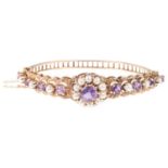 A late 20th century 9ct gold amethyst and pearl cluster hinged bangle, no maker's mark of date