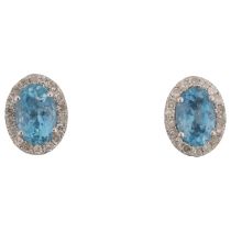 A pair of 9ct white gold aquamarine and diamond oval cluster earrings, with stud fittings, 8.3mm,