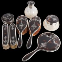 An Art Deco George V silver and tortoiseshell pique inlaid 8-piece dressing table vanity set, Adie