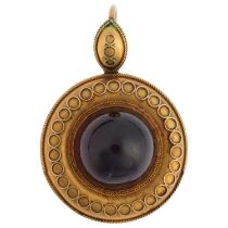 A Victorian Etruscan Revival garnet mourning locket pendant, circa 1880, centrally set with foil-