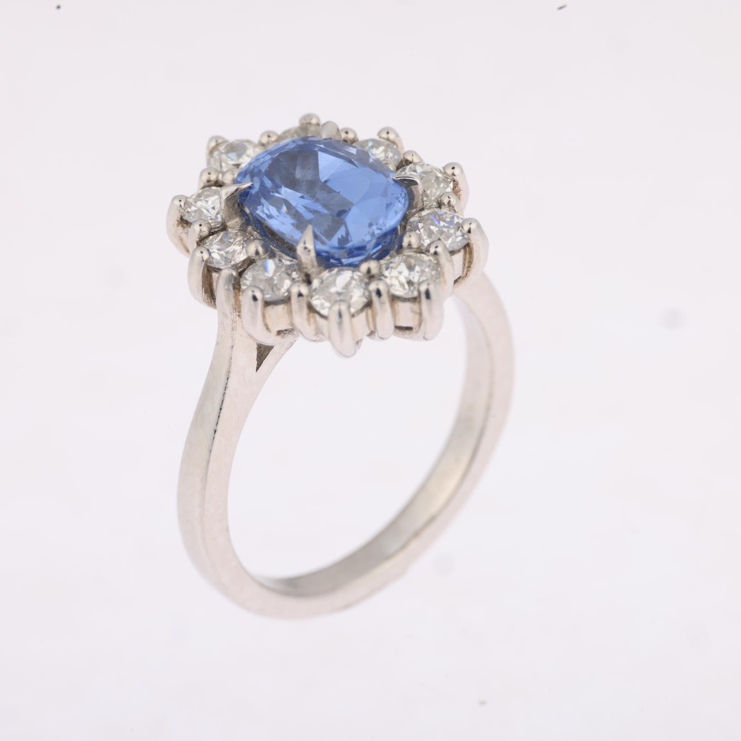 A Sri Lankan 'No Heat' sapphire and diamond oval cluster ring, centrally claw set with 2.44ct oval - Image 2 of 4