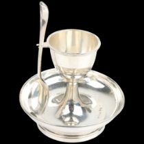 An Art Deco George V silver egg cup and spoon set, Marson & Jones, Birmingham 1925, stand