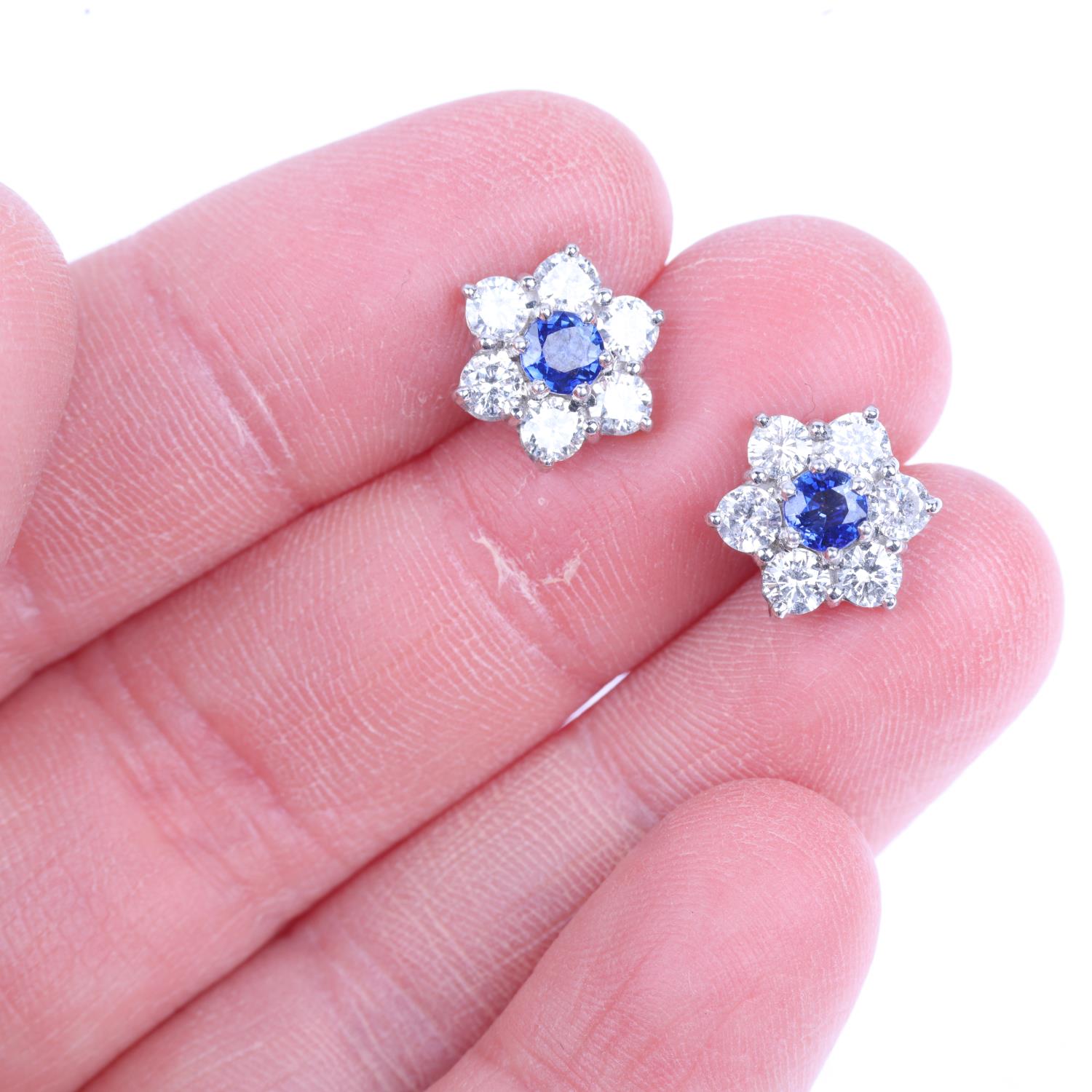 A pair of 18ct white gold sapphire and diamond flowerhead cluster earrings, claw set with round- - Image 3 of 3