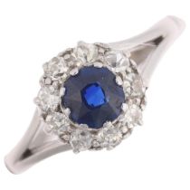 A 9ct white gold sapphire and diamond cluster ring, claw set with round-cut sapphire and single-