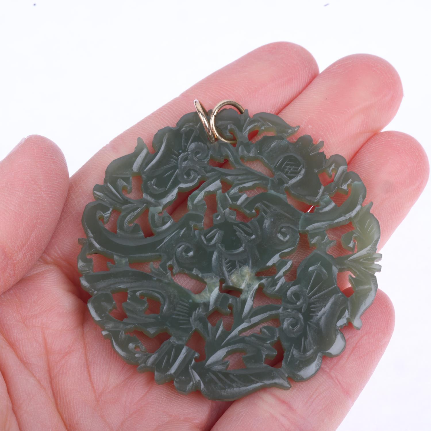 A Chinese jade 'Bat' disc pendant, carved and pierced decoration, 52.4mm, 13g No damage or repair - Image 4 of 4