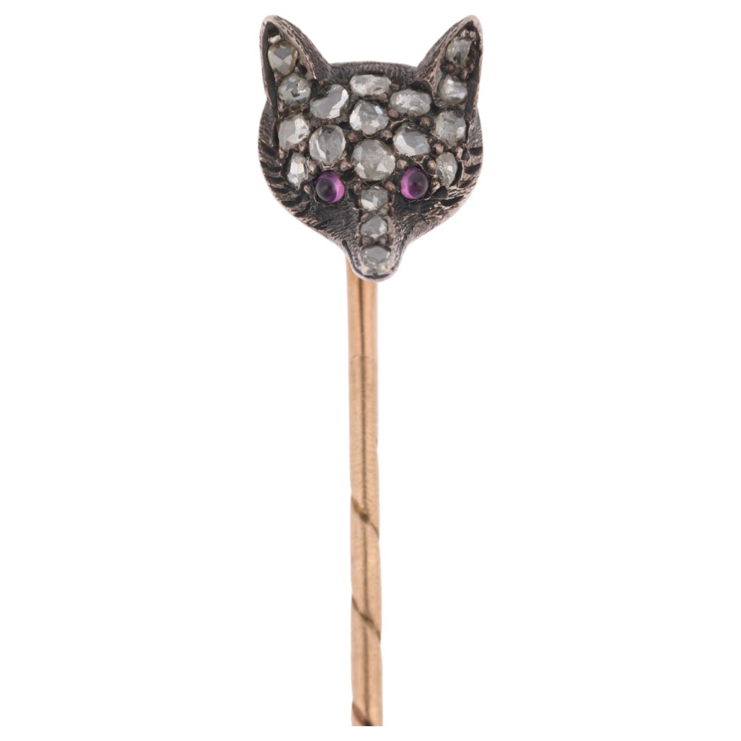 An Antique ruby and diamond fox-head stickpin, circa 1900, pave set with round cabochon ruby eyes