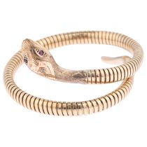 A late 20th century 9ct gold ruby figural coiled snake bangle, maker C&F, Birmingham 1971,