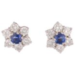 A pair of 18ct white gold sapphire and diamond flowerhead cluster earrings, claw set with round-