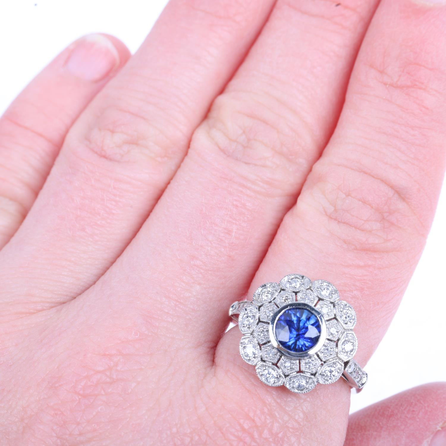 A platinum sapphire and diamond flowerhead cluster ring, maker JC, set with 1ct round-cut sapphire - Image 4 of 4