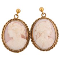 A pair of 9ct gold pink coral cameo earrings, relief carved depicting female profiles, with stud