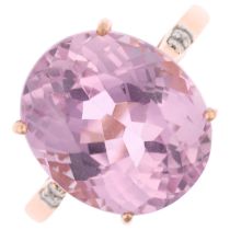 A modern 14ct rose gold kunzite and diamond dress ring, claw set with oval mixed-cut kunzite,