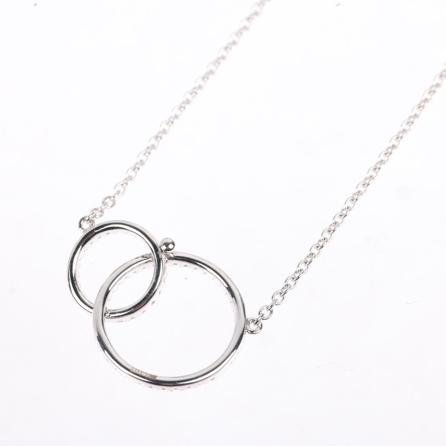 A modern 18ct white gold diamond double-hoop pendant necklace, LD Ltd modelled as 2 interlocking - Image 3 of 4