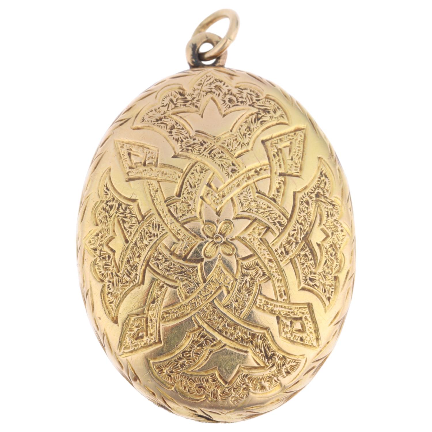An Antique photo locket pendant, allover engraved decoration, 32.3mm, 7.6g Both sides have several