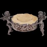 A German silver cherub dressing table ring holder/pin cushion, Neresheimer, Hanau, circa 1900,