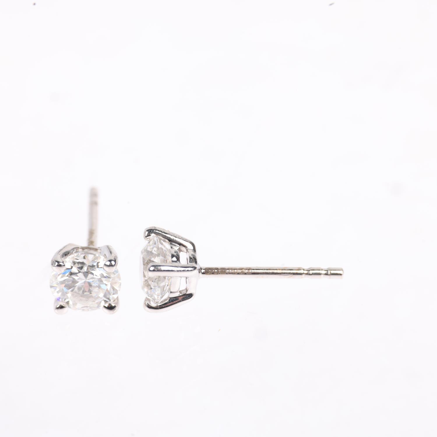 A pair of 18ct white gold 1.01ct solitaire diamond stud earrings, each claw set with individually - Image 2 of 4