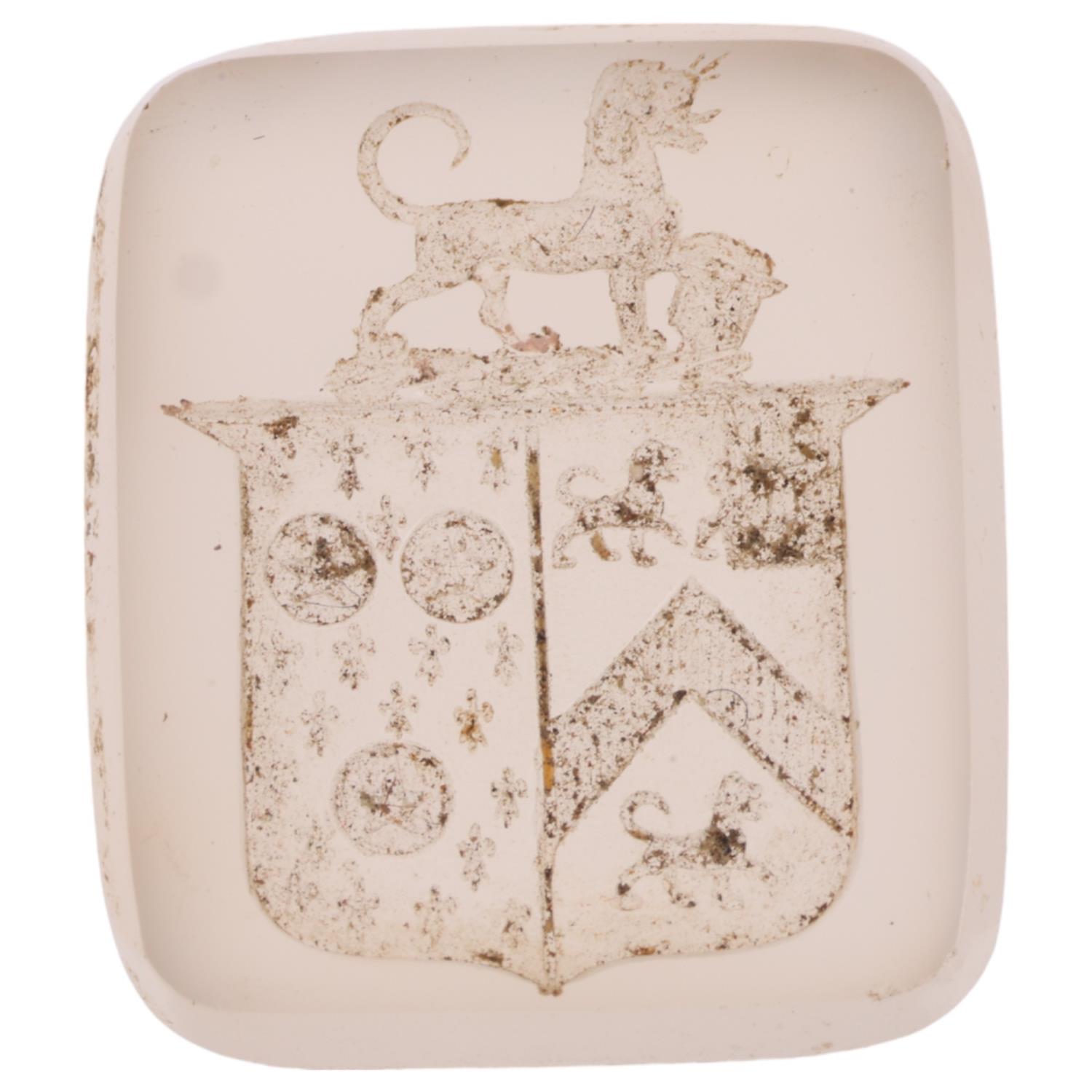 A 19th century chalcedony armorial seal ringstone, intaglio carved with shield banner surmounted