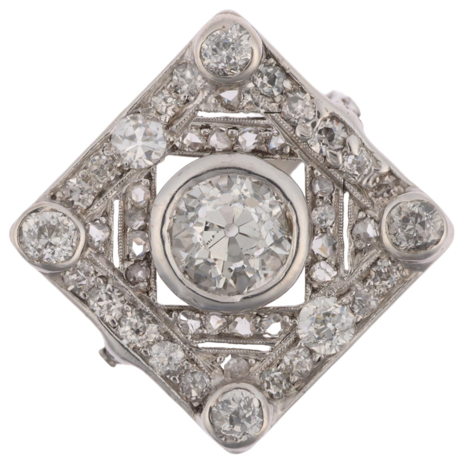 An Art Deco platinum diamond geometric panel ring, centrally set with 1.15ct old European-cut