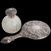An Edwardian silver dressing table hand mirror, Birmingham 1903, and a silver-mounted glass scent