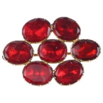 A Georgian flat-top red paste cluster mourning brooch, circa 1820, apparently unmarked foiled