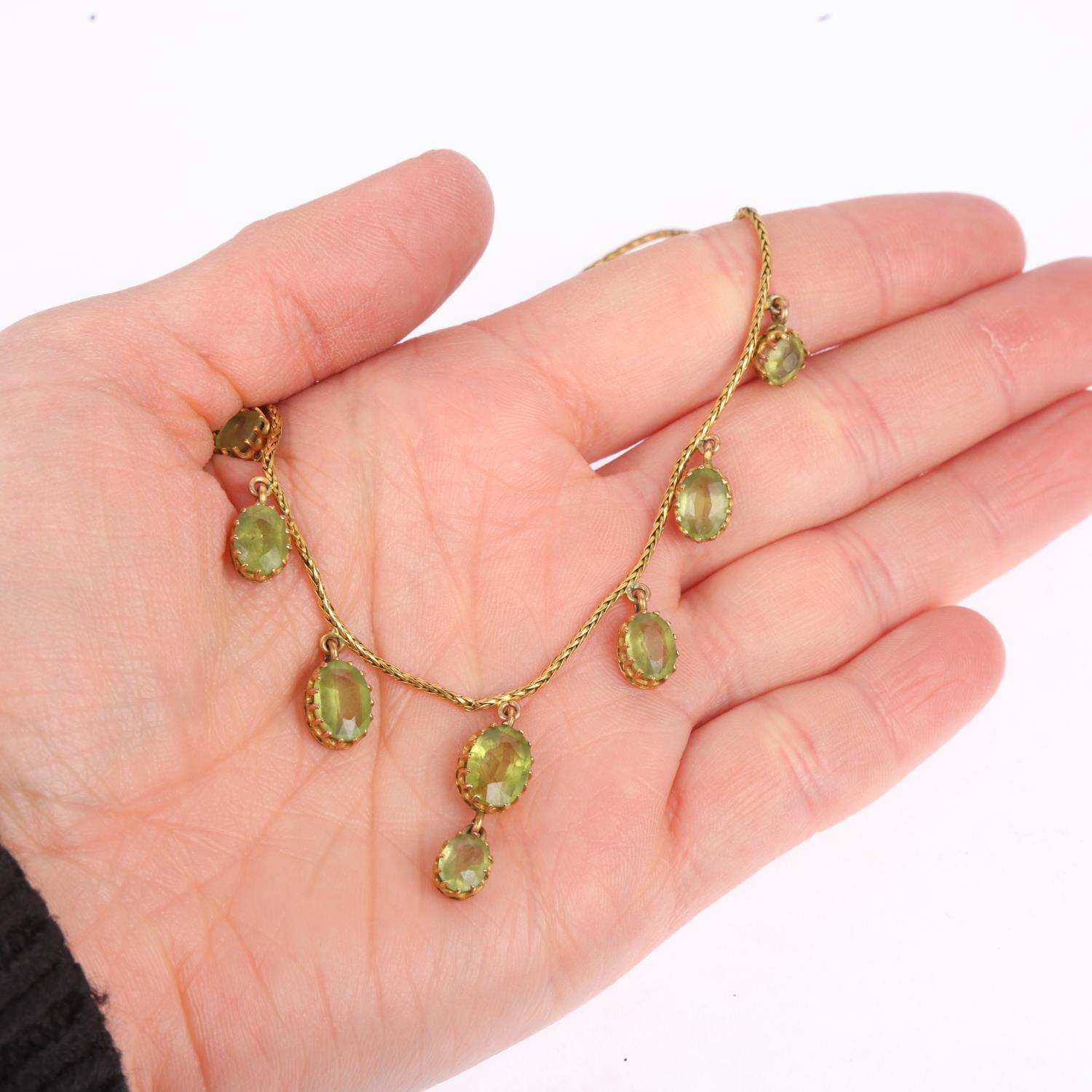 An Edwardian peridot fringe necklace, circa 1910, claw set with oval mixed-cut peridot drops, on - Image 4 of 4