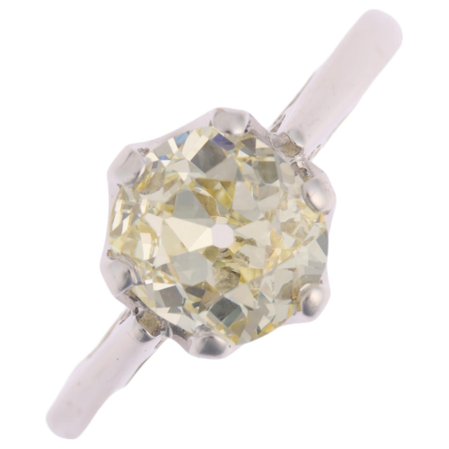 An 18ct white gold 1.9ct solitaire diamond ring, claw set with 1.9ct light yellow old-cut diamond,