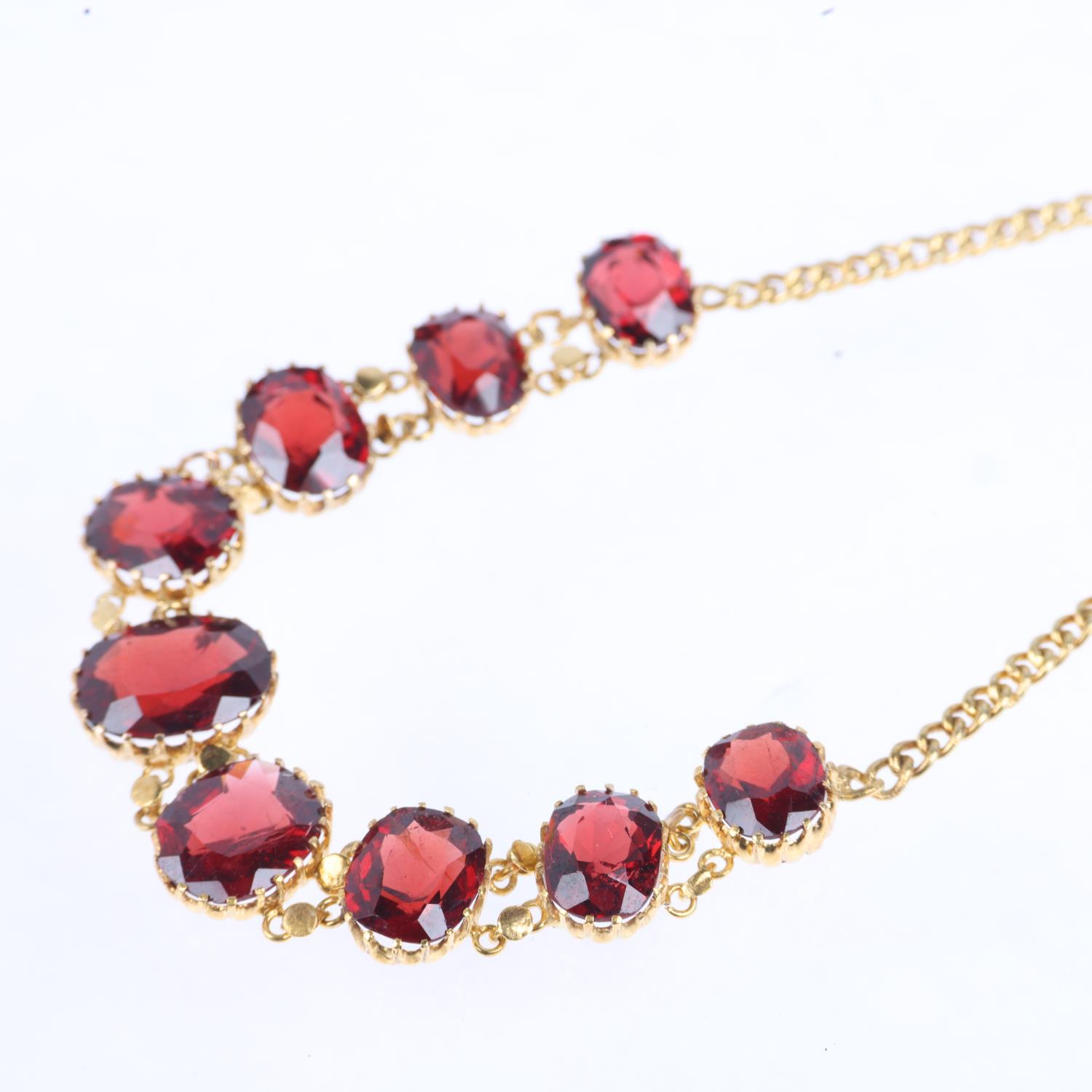 An Edwardian graduated garnet line bracelet, claw set with oval mixed-cut garnets, on curb link - Image 3 of 4