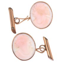 A pair of early 20th century pink coral cameo cufflinks, relief carved depicting female profiles,