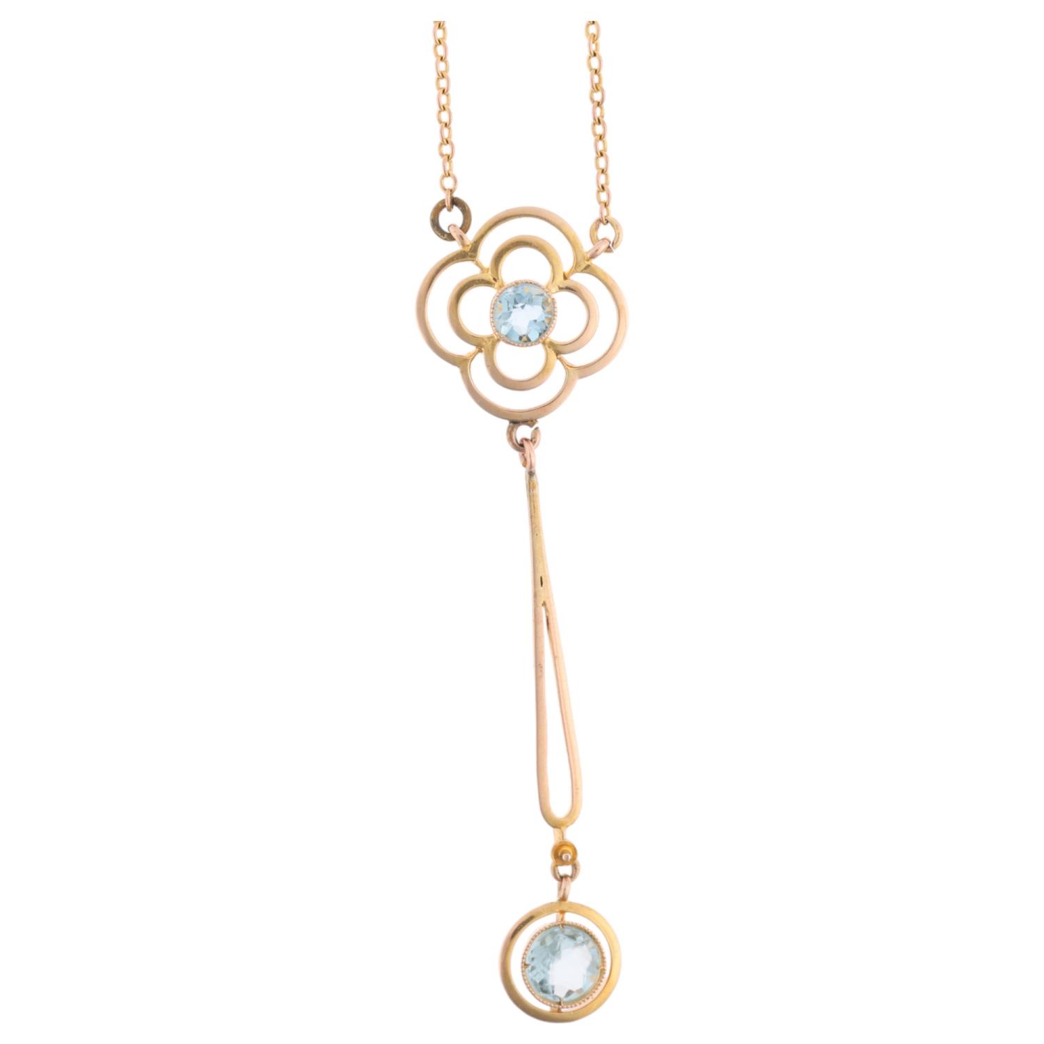 An Edwardian 9ct gold aquamarine openwork drop pendant necklace, on integral 9ct fine cable link