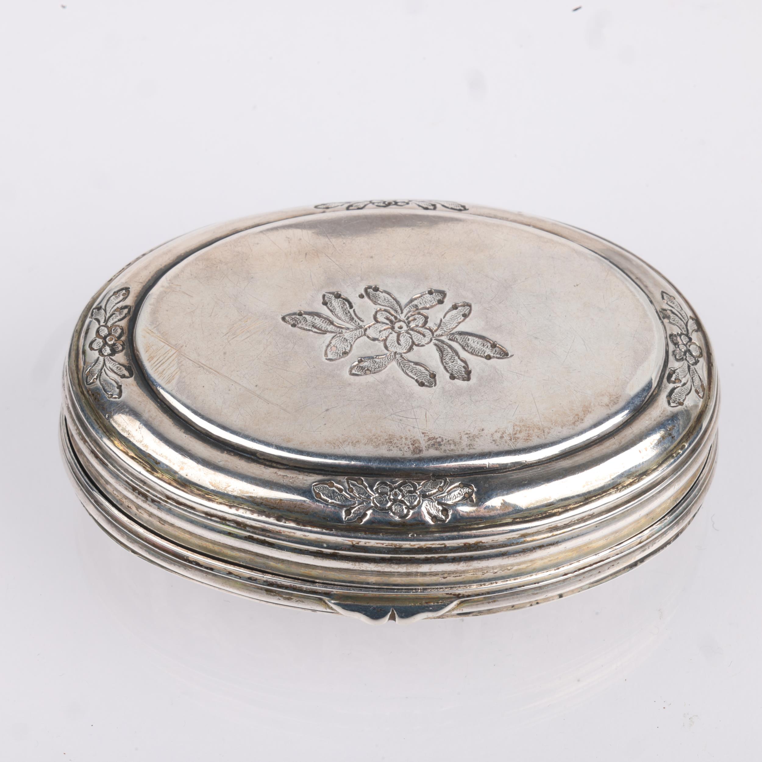 An 18th century Continental silver snuffbox, oval form with relief embossed weapon armaments - Image 2 of 3