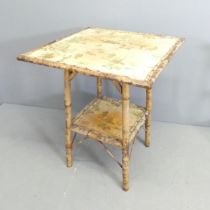 An early 20th century bamboo two-tier occasional table with applied Oriental decoration. 58x72cm.