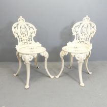 A pair of painted cast iron Coalbrookdale style garden chairs.