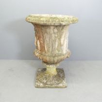 A reconstituted stone Grecian design two-section garden urn on stand. 64x91cm.