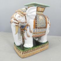 A painted ceramic elephant design garden seat.54x58x28cm.  Good overall condition. Some glazing loss