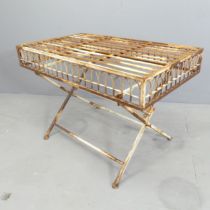 A vintage painted metal folding garden table, with slatted top and wirework arch detail to sides.