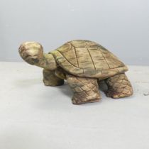 A carved and weathered teak garden sculpture, study of a tortoise. Length 50cm.