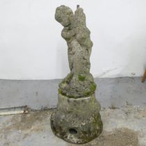 A two-section weathered stone water feature, in the form of a boy holding fish. Height 92cm.