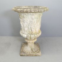 A reconstituted stone Grecian design garden urn on stand. Indistinctly signed. 64x93cm.