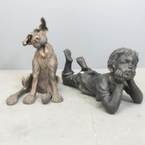 A resin garden pond spitter in the form of a boy, length 50cm, and a resin dog ornament. (2)