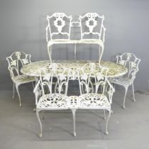 A painted aluminium oval garden table, 180x70x89cm, with two matching two-seater benches and arm