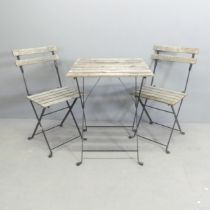 A Parisienne folding bistro café table, 55x72cm, and two matching chairs.