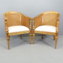 FRANK HUDSON - A pair of Spire tub chairs, with double-caned back, upholstered seat and maker's