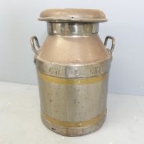 A copperised milk churn, marked CWS. 37x52cm. Top is seized on.