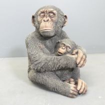 A painted concrete garden sculpture, study of a monkey mother with child. Height 31cm.