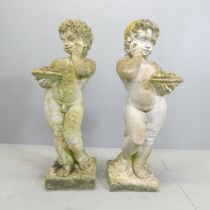 A pair of weathered stone Putti / cherubs of male and female form. Height 73cm.