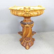 An antique majolica two-section jardiniere stand, with foliate and fish decoration. Overall 78x97cm.